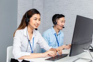 Call center agents using computers working in office